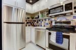 Modern kitchen appliances include an electric range/dishwasher